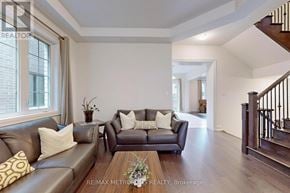 Vaughan (Vellore Village) house for rent - A living room with a brown leather couch and a coffee table.