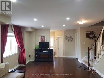Brampton (Fletcher's Creek Village) house for rent - A living room with a television and a staircase.