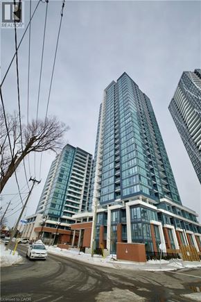 Kitchener condo for rent - A tall building with many windows is in the foreground of the image.