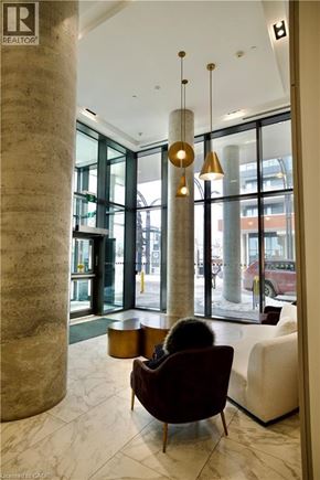 Kitchener condo for rent - A brown chair is in front of a white sofa.