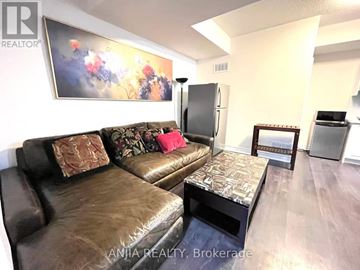 Richmond Hill (Westbrook) house for rent - A living room with a brown leather couch and a painting on the wall.