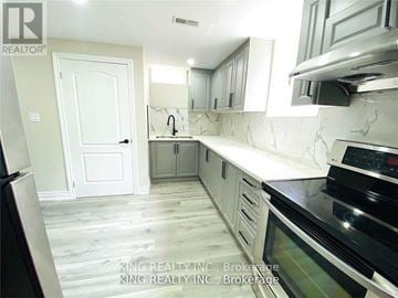 Brampton (Northwest Brampton) house for rent - A kitchen with a black stove top oven and white cabinets.
