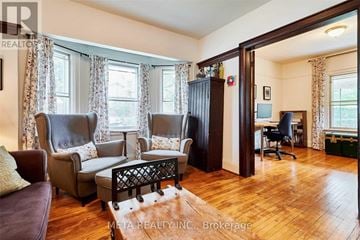 Toronto (Birchcliffe-Cliffside) house for rent - A living room with a brown leather chair and a wooden coffee table.
