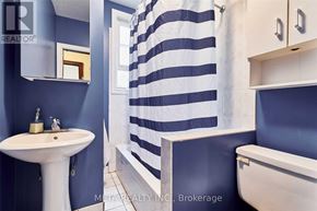Toronto (Birchcliffe-Cliffside) house for rent - A white sink is on a blue wall next to a white toilet.