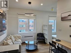 St. Catharines apartment for rent - A living room with a couch, chairs, and a coffee table.