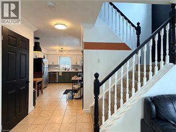 Waterloo house for rent - A living room with a couch and a staircase.