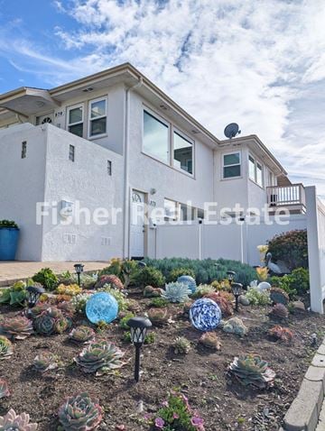 Pismo Beach house for rent - A white house with a garden in front.