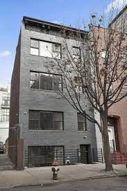 Brooklyn apartment for rent - A tall building with a fire hydrant in front of it.