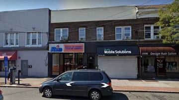 Perth Amboy apartment for rent - A car is parked in front of a building with a sign that says "Mobile Solutions".