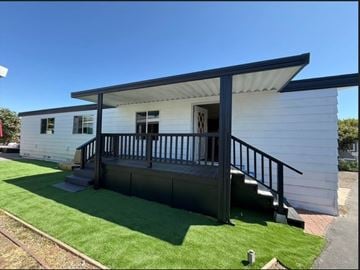 Goleta apartment for rent - A white house with a black roof and a black railing.