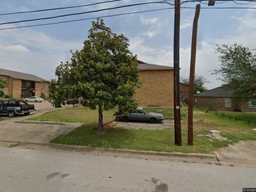 Temple apartment for rent - A tree in front of a building with a car parked behind it.