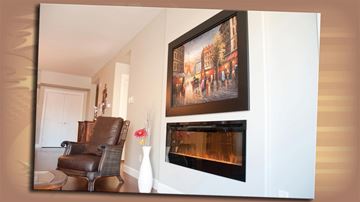 Moncton apartment for rent - A painting of a street scene hangs above a fireplace in a living room.