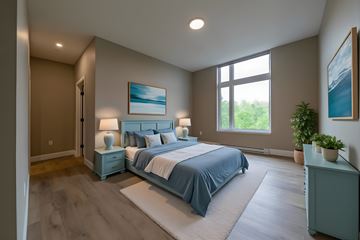 Shediac apartment for rent - A bedroom with a large bed and a painting on the wall.