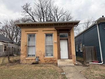 Louisville apartment for rent - A small brown house with a white door and a small porch.