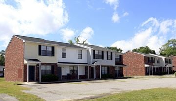 North Charleston apartment for rent - A row of houses with a gravel driveway in front.