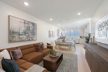 Midvale townhouse for rent - A living room with a brown couch and a painting on the wall.