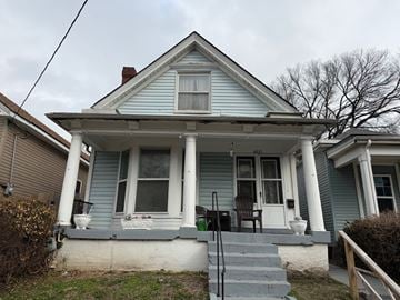 Louisville apartment for rent - A blue house with a porch and a front yard.