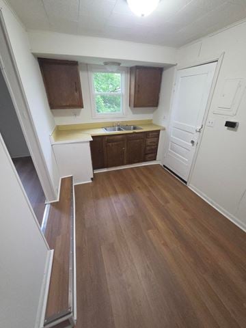 Lima apartment for rent - A kitchen with wooden floors and white walls.