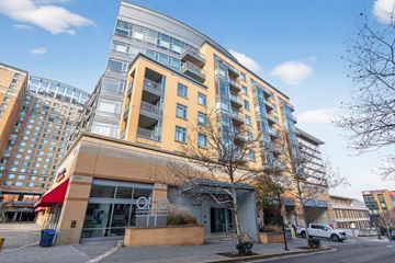 Hyattsville apartment for rent - A modern building with a glass facade is situated in an urban area.