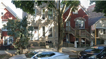 Chicago apartment for rent - A tree in front of a red brick house.