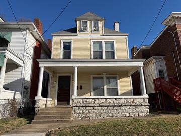 Louisville apartment for rent - A yellow house with a red door and a small porch.