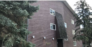 Edmonton apartment for rent - A red building with a black roof and a sign that says "Frontenac".