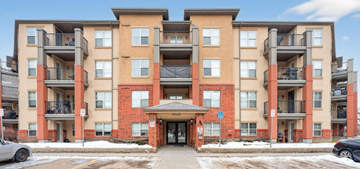 Edmonton apartment for rent - Apartment building with a red brick facade and multiple balconies.