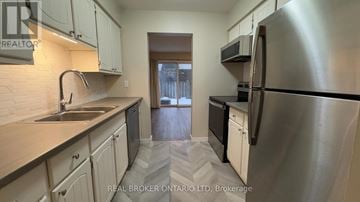 London South (South R) townhouse for rent - A kitchen with a sink, stove, and refrigerator.