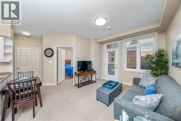 St Clair apartment for rent - A living room with a grey couch and a wooden chair.