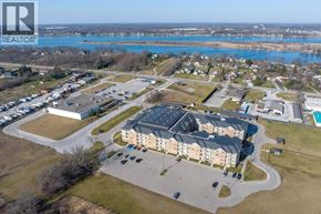 St Clair apartment for rent - A realtor logo is on the top left corner of an aerial view of a residential area with a swimming pool and a large building.