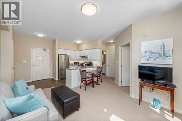 St Clair apartment for rent - A living room with a grey couch and a black ottoman.