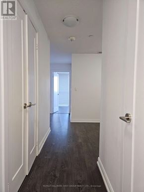 Toronto (Agincourt South-Malvern West) condo for rent - A hallway with a table and chairs at the end.