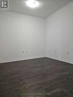 Toronto (Agincourt South-Malvern West) condo for rent - A bathroom with a toilet, a glass shower door, and a brown rug.