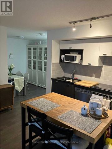 Toronto (Agincourt South-Malvern West) condo for rent - A kitchen with a wooden table and chairs.