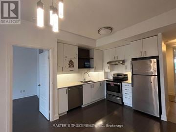 Markham (Unionville) condo for rent - A kitchen with white cabinets and stainless steel appliances.