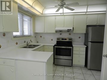 Mississauga (Erindale) apartment for rent - A white kitchen with a stove top oven and a refrigerator.