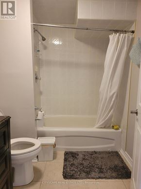 Brampton (Fletcher's Creek South) apartment for rent - A white bathroom with a toilet, tub, and shower.