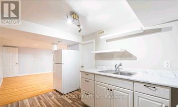 Milton (Mn Milton North) apartment for rent - A kitchen with white cabinets and a white fridge.