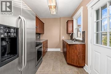 Windsor apartment for rent - A kitchen with a stainless steel refrigerator and wooden cabinets.