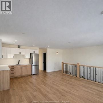 Windsor apartment for rent - A spacious kitchen with wooden floors and a stainless steel refrigerator.
