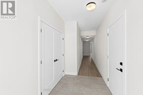 Brockville apartment for rent - A long hallway with white doors and a light on the ceiling.