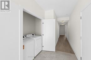 Brockville apartment for rent - A white laundry room with a washer and dryer.