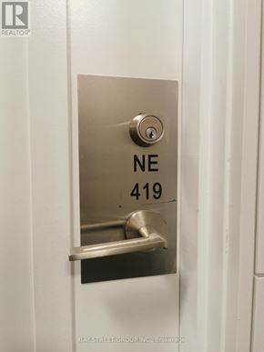 Richmond Hill (Langstaff) condo for rent - A door handle with the label NE 419 on it.