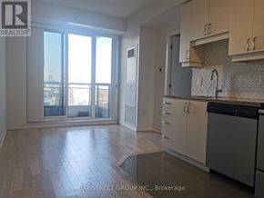 Richmond Hill (Langstaff) condo for rent - A kitchen with a sink, stove, and cabinets.