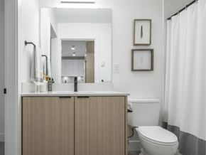 Langley apartment for rent - A white toilet sits next to a sink in a bathroom.