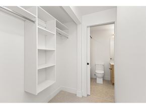 Langley apartment for rent - A bedroom with a large bed and a view of trees outside the window.