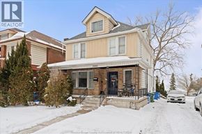 Windsor apartment for rent - A house with a snowy front yard and a car parked in front.