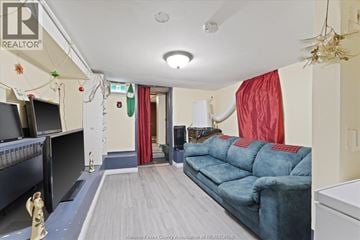 Windsor apartment for rent - A living room with a blue couch and a television.