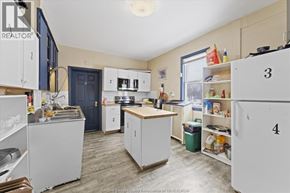 Windsor apartment for rent - A kitchen with white cabinets and a blue door.