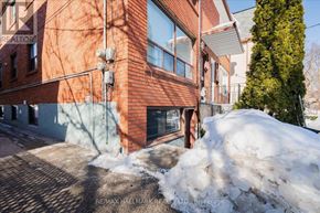 Toronto (East End-Danforth) duplex for rent - A red brick building with a snow pile in front.